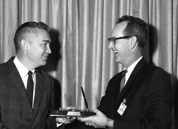 Ralph Ragan Awarding Norm Sears with the Apollo 3% Cost Reduction Award Ralph Ragan Awarding Norm Sears with the Apollo 3% Cost Reduction Award