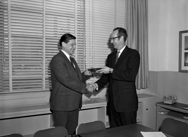 Ain Laats Receiving Cost Reduction Award from Ralph Ragan Ain Laats Receiving Cost Reduction Award from Ralph Ragan