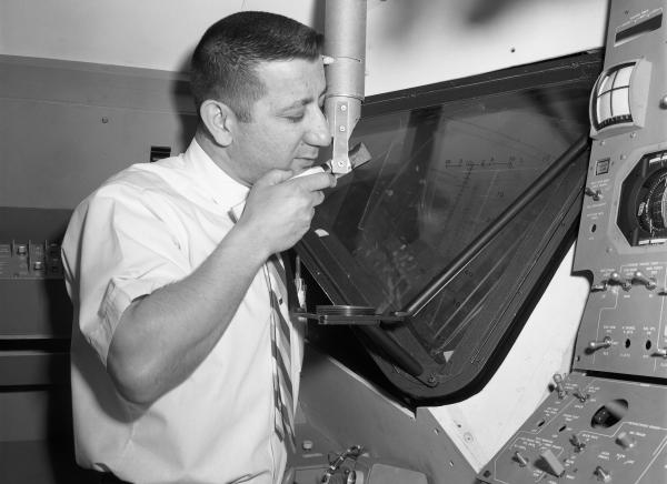 Engineer Joseph Martori Viewing Launching Sight Designator in Apollo LEM Engineer Joseph Martori Viewing Launching Sight Designator in Apollo LEM