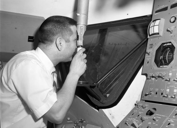 Engineer Joseph Martori Viewing Launching Sight Designator in Apollo LEM Engineer Joseph Martori Viewing Launching Sight Designator in Apollo LEM