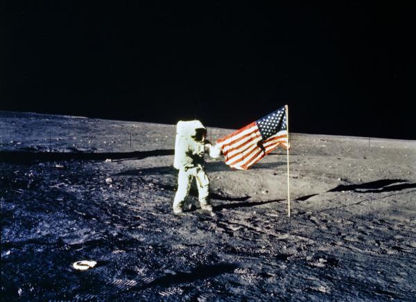 Apollo 12 Astronaut with American Flag on Lunar Surface Apollo 12 Astronaut with American Flag on Lunar Surface